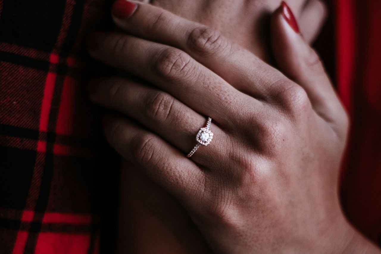 Person showcasing marvelous engagement ring with diamond pave