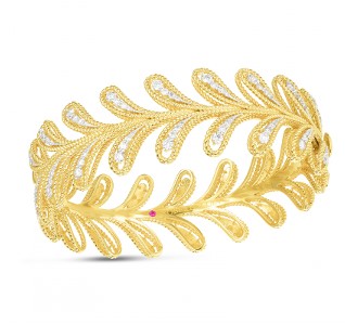 A vine-like yellow gold bangle with diamond details