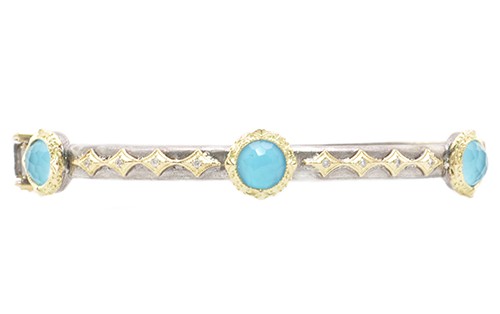 Round faceted turquoise on a sterling silver and yellow gold bangle that can be stacked or worn alone