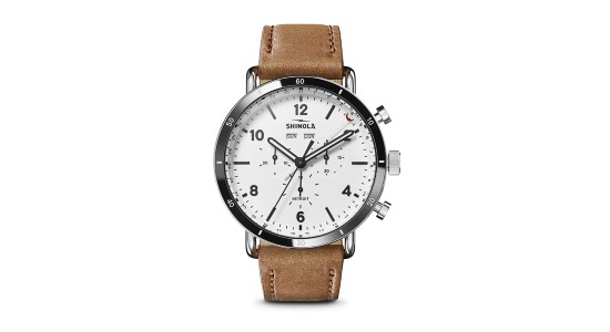 A silver Shinola watch with a white dial and tan leather strap