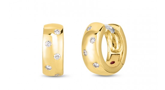 A yellow gold pair of huggies earrings inlaid with diamonds