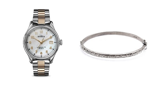 A sterling silver Shinola watch with gold detail next to a sterling silver bangle bracelet