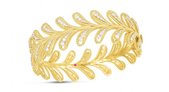 a yellow gold and diamond bracelet featuring mirrored leaf motifs