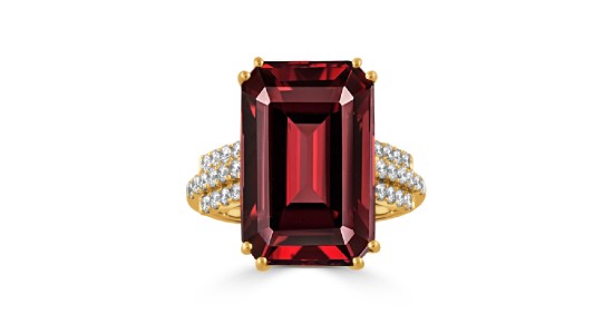 a yellow gold fashion ring featuring a large red garnet