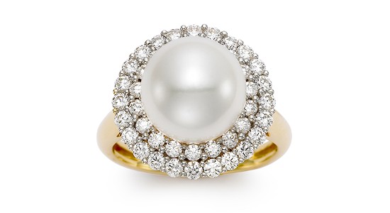 a yellow gold fashion ring featuring a large pearl center stone surrounded by a double halo of diamonds