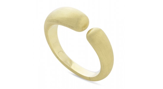 a yellow gold cuff bracelet with a chunky, organic form and finish