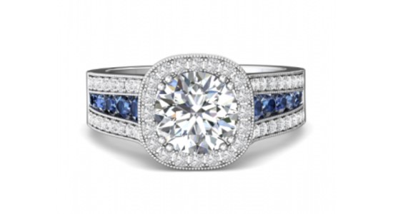 a large engagement ring with blue gemstone details and milgrain edges