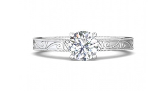 a white gold diamond engagement ring with metalwork filigree