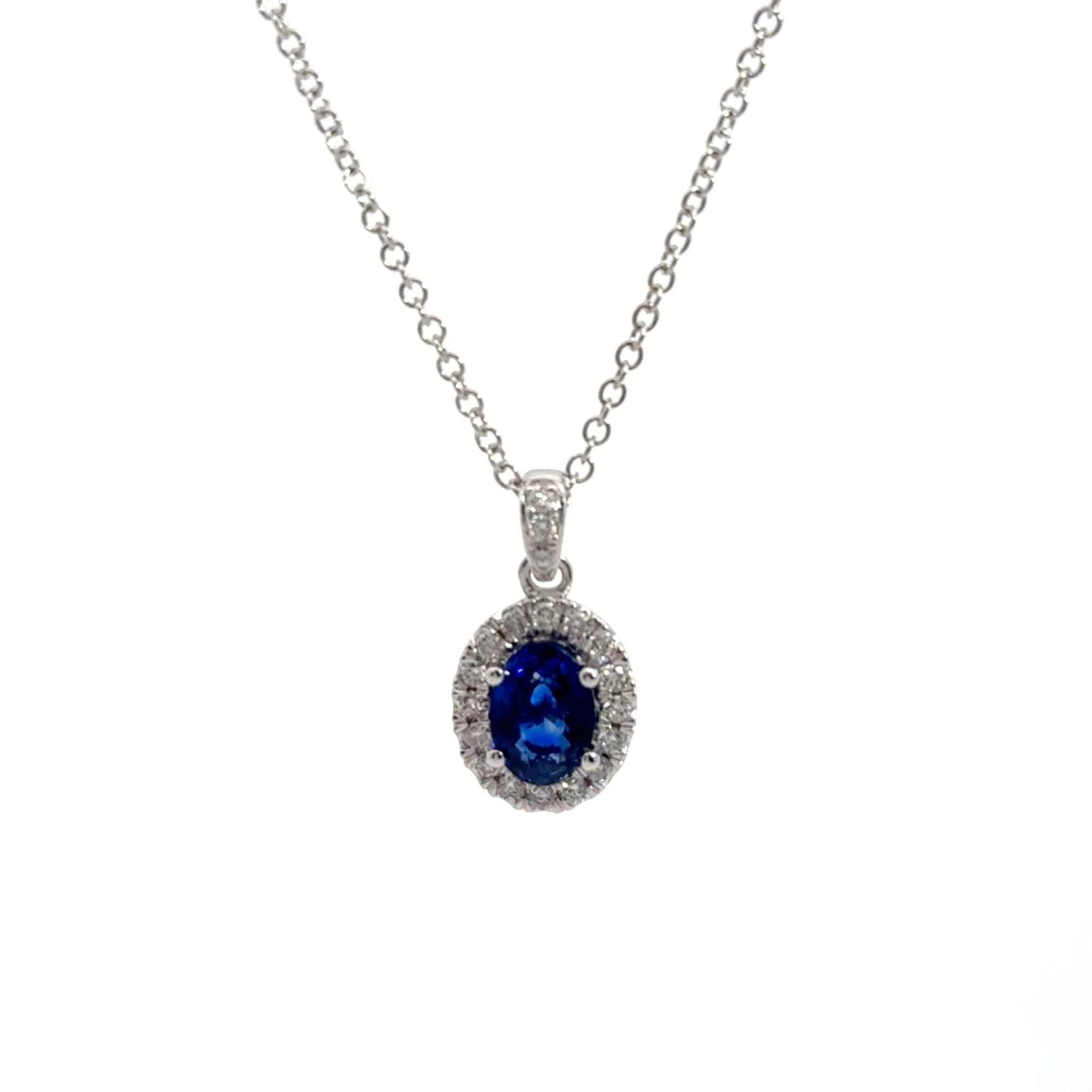 A white gold halo sapphire pendant
