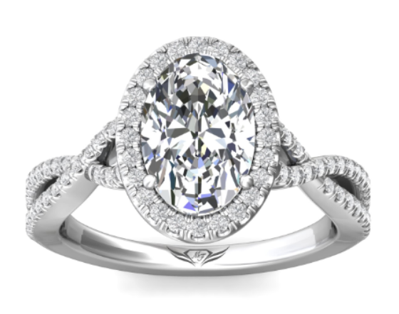 A white gold halo engagement ring with a split-shank diamond encrusted band.