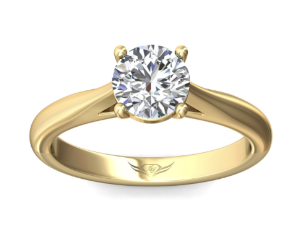 A yellow gold solitaire round cut diamond engagement ring.
