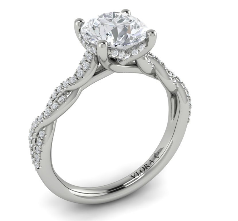 A white gold side stone four prong diamond engagement ring.