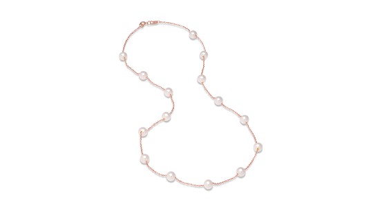a rose gold chain necklace featuring station set pearls