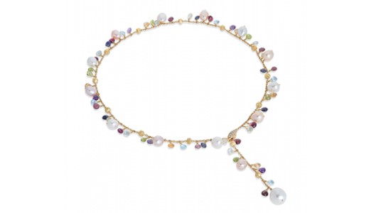 a yellow gold lariat necklace featuring a variety of multicolored gemstones