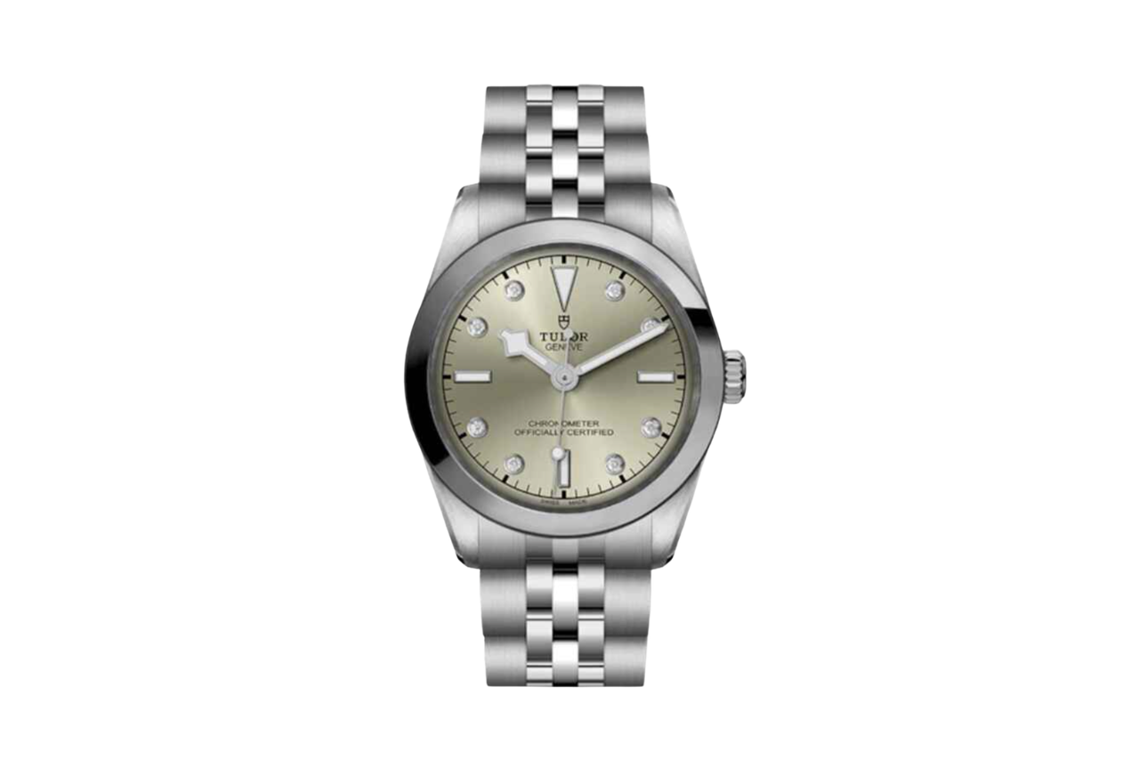 A silver watch with a stunning dial that has a slight green hue and diamond accents.