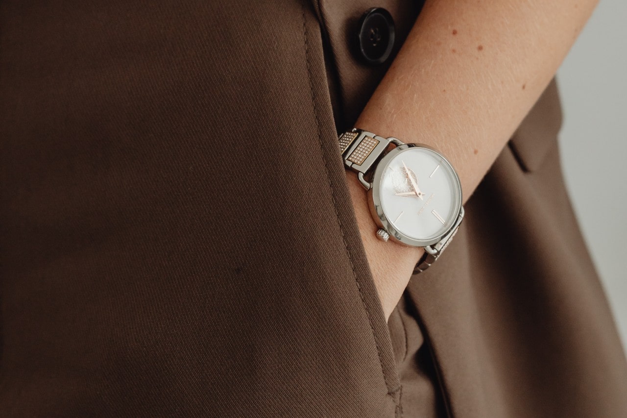 lady’s hand in her pocket wearing a dress watch