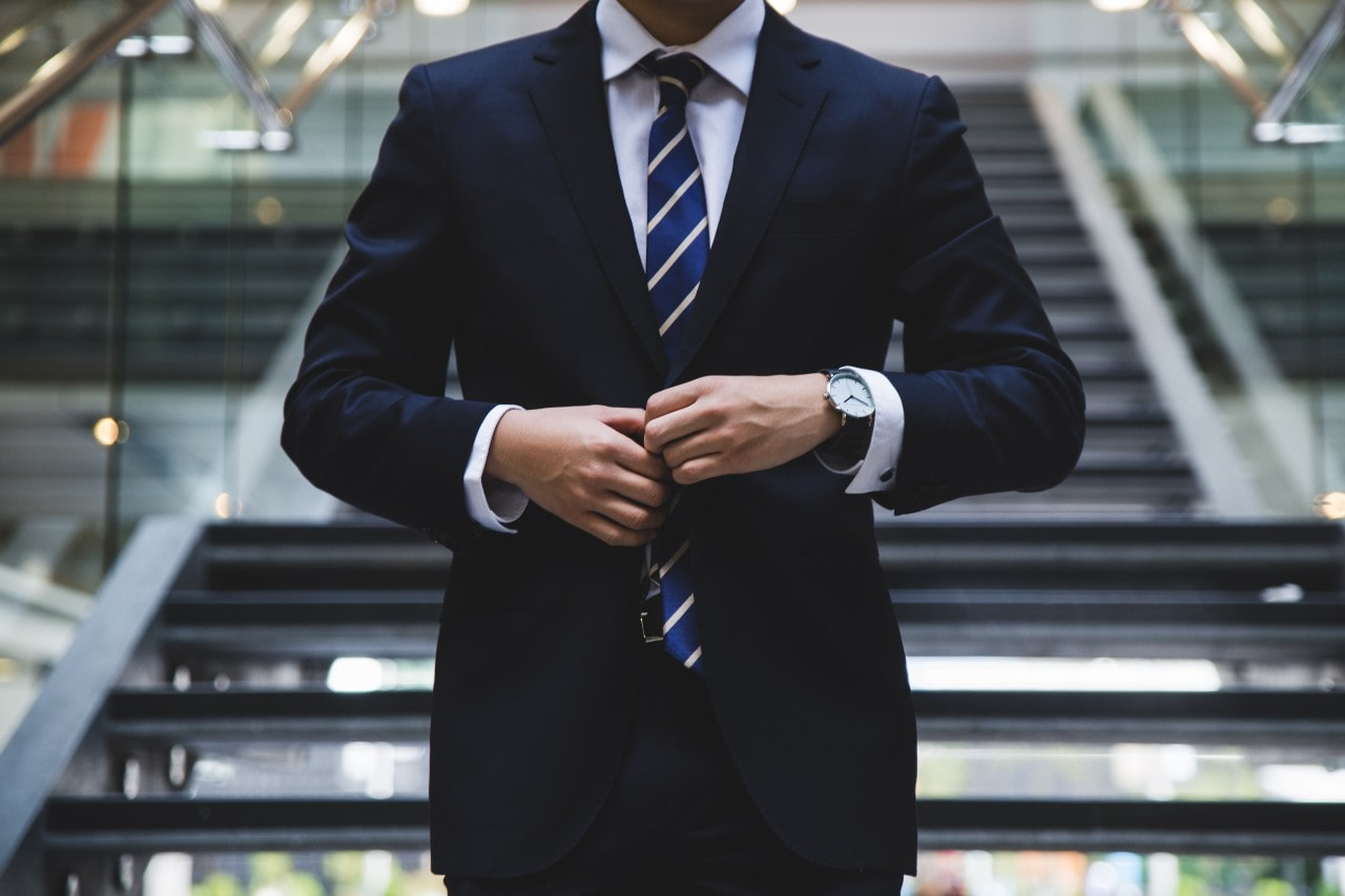 man in a suit wearing a luxury watch man in a suit wearing a luxury watch