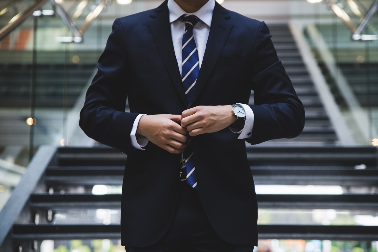 man in a suit wearing a luxury watch